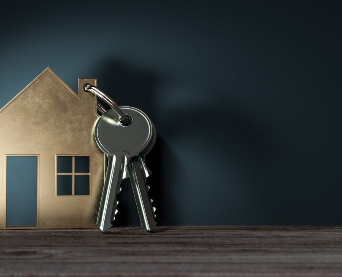picture of keys and a house-shaped keychain against a blue background