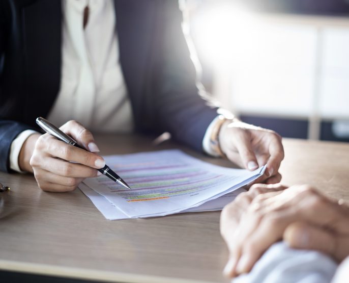 two people in office signing about to sign a lease rental agreement