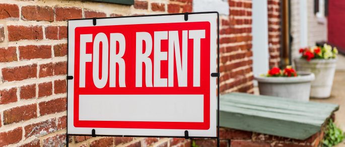 Red for rent sign outside of rented apartments